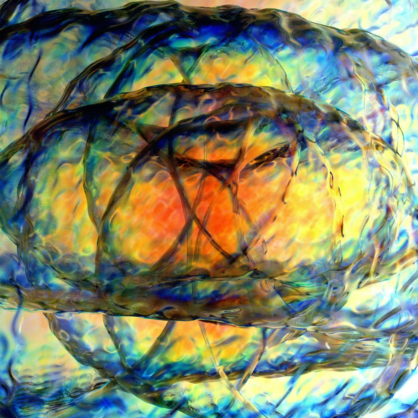 Abstract close-up of layered blue, yellow and orange glass textures with crossing dark lines